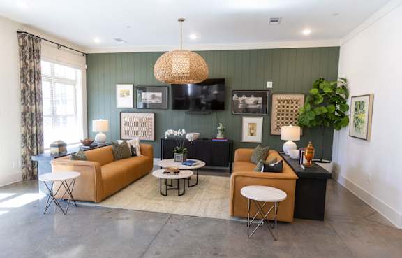 A living room with a sofa, a chair, a table, and a television.
