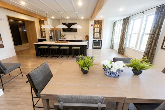 A modern kitchen with a dining table and chairs.