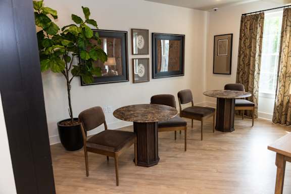 A living room with a table and chairs.