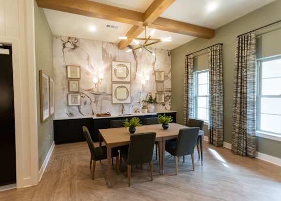 A dining room with a wooden table and chairs.