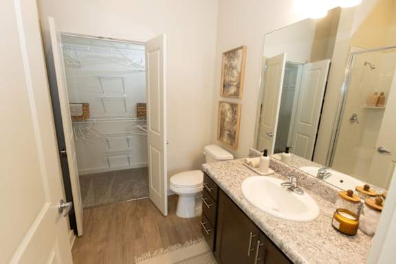 A bathroom with a toilet, sink, and shower.