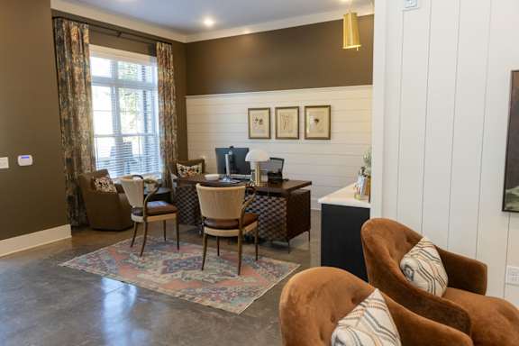 A living room with a brown chair and a patterned rug.