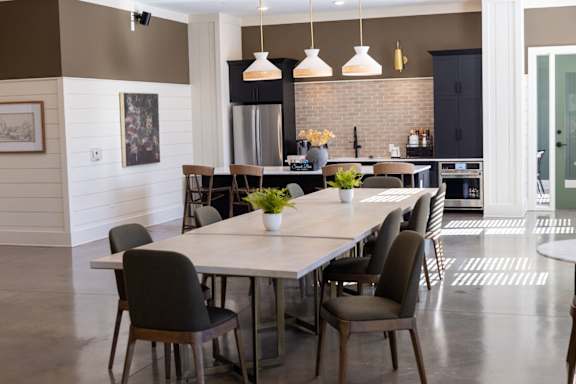 A modern kitchen with a dining table and chairs.
