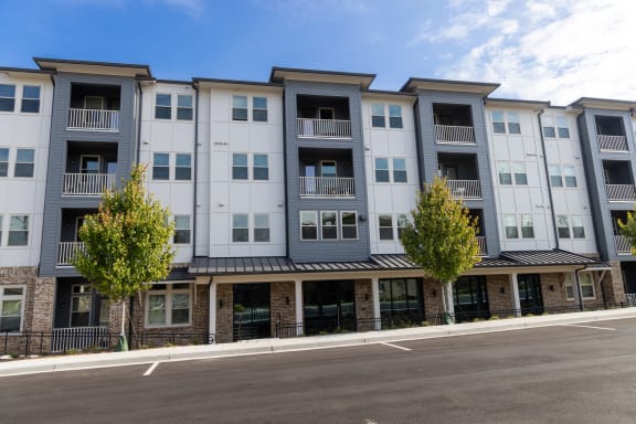an exterior view of an apartment building on a city street