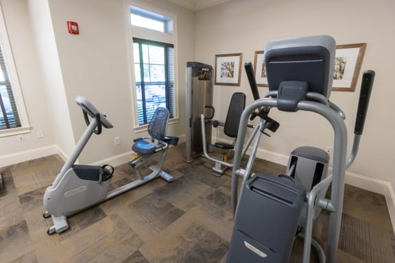 a gym with various exercise equipment in a therapy room