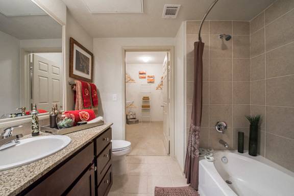 A bathroom with a white tub and a sink.