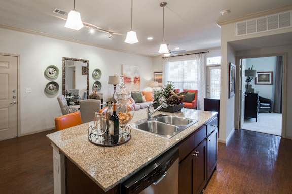 A kitchen with a granite countertop and a sink.