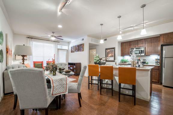 A kitchen with a table and chairs in the middle of the room.