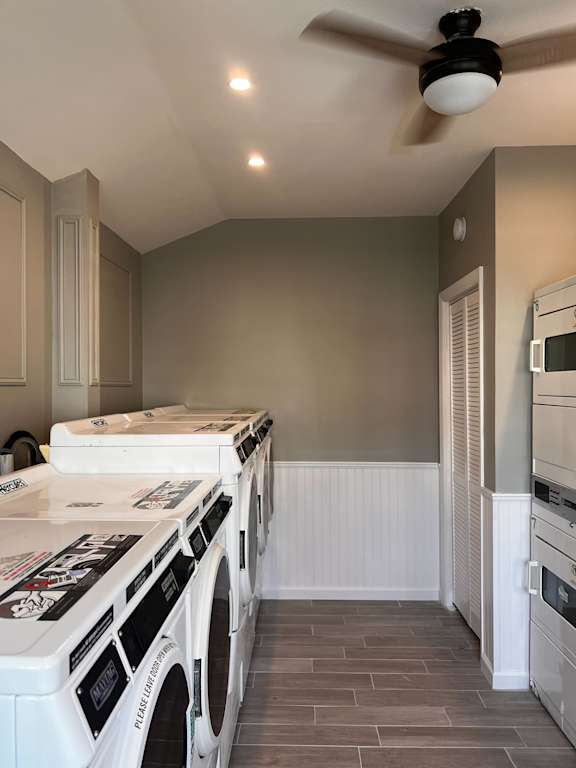 Remodeled kitchen with white appliances and a ceiling fan at Brookwood at Bay Shore in Bay Shore, NY 11706