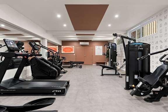 A gym with treadmills and exercise equipment.