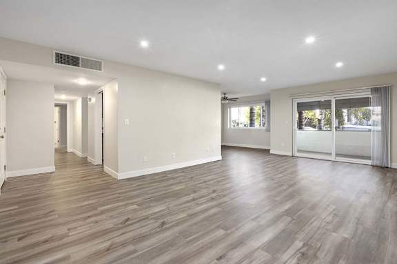 a renovated living room with white walls and wood flooring at White Oak Terrace Apartments, Encino, 91316