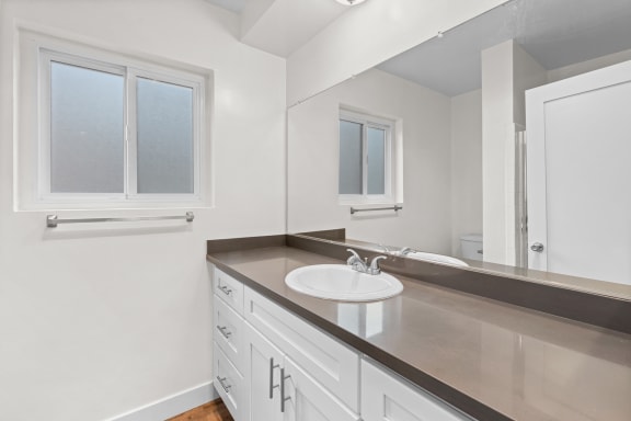 an empty bathroom with a sink and a mirror