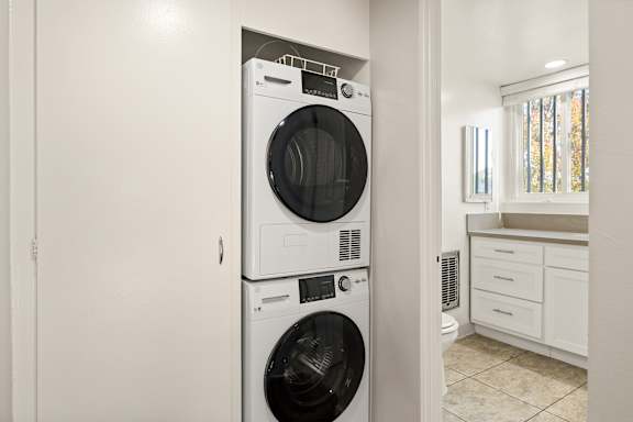 A white washing machine and dryer in a laundry room.