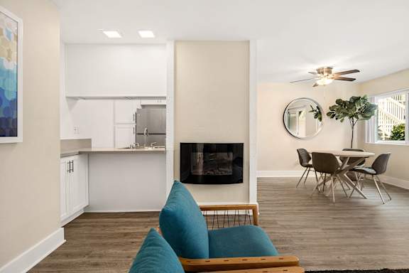 A modern living room with a fireplace and a dining table.