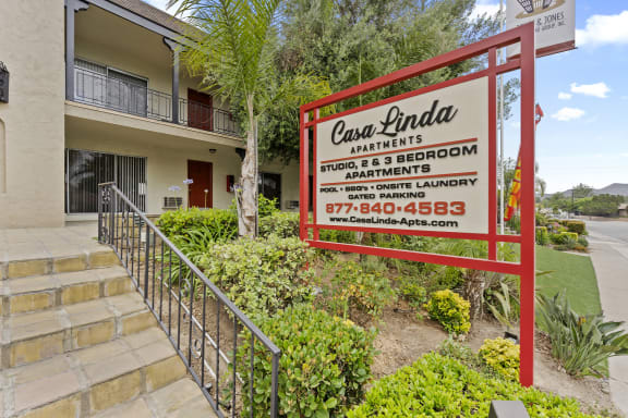 a sign in front of a condominium building