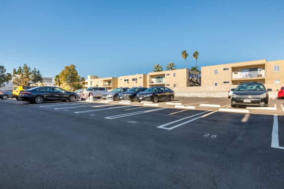 a parking lot with cars parked in front of a building at Parkview Terrace Apartments, Sherman Oaks, CA, 91423