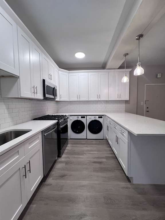 a white kitchen with white cabinets and stainless steel appliances at Huntington Green Apartments, University Heights, 44118