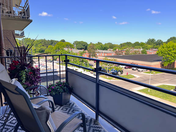 a balcony with a view of a parking lot and trees at Huntington Green Apartments, University Heights, Ohio