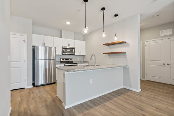 a kitchen with an island and stainless steel appliances
