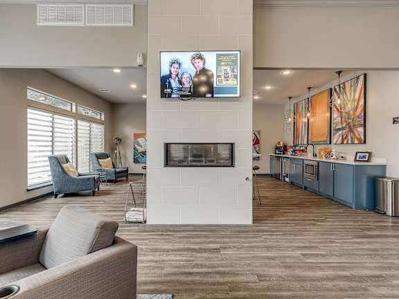 Community room lounge with flat screen TV and fireplace