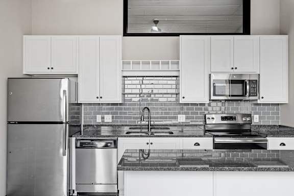Kitchen with White Cabinetry and Stainless Steel Appliances