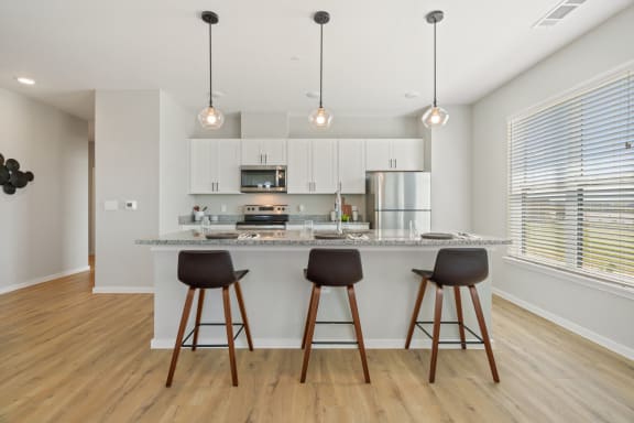 Expansive Kitchen Island with Overhead Lighting