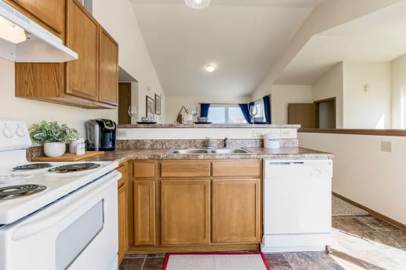 Fully-Equipped Kitchen With White Appliances