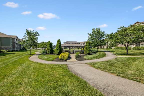 A pathway leads to a building with a courtyard in front.