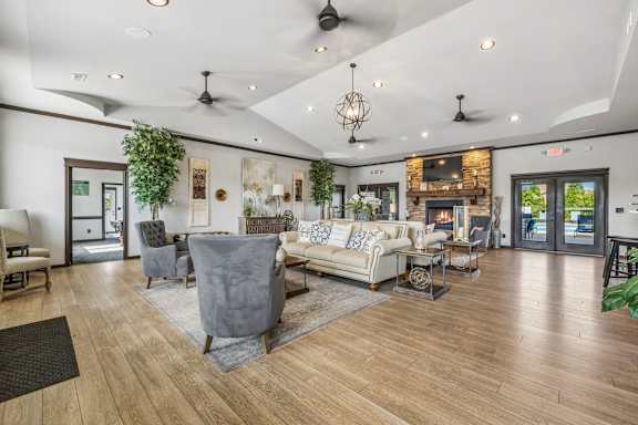 A spacious living room with a fireplace and a variety of seating options.