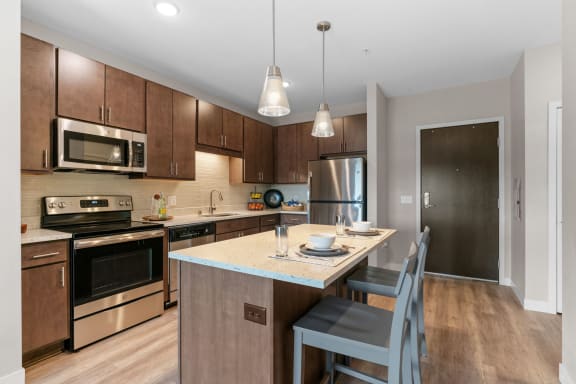 Kitchen with Dark Brown Cabinetry and Stainless Steel Appliances
