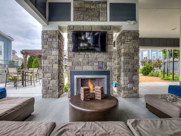 A stone fireplace with a flat screen TV above it.
