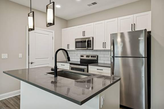 Kitchen with White Cabinetry and Stainless Steel Appliances