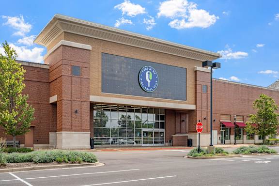 A building with a large glass window and a sign on it.