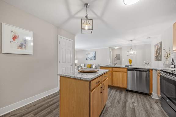 A kitchen with wooden cabinets and a marble countertop.