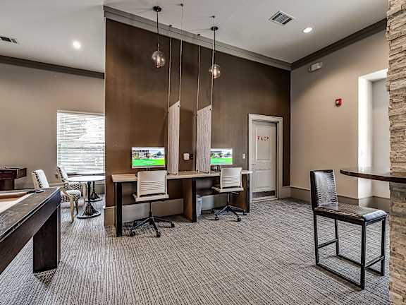 A conference room with a stone pillar and a fire extinguisher on the wall.