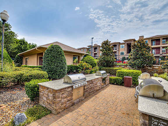 A residential area with a brick pathway and a sign that says "Turn Gas Off At This Point.".