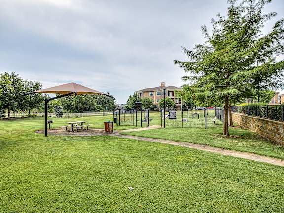 A park with a picnic table and a playground.