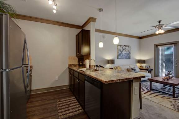 Kitchen with Dark Brown Cabinetry and Stainless Steel Appliances