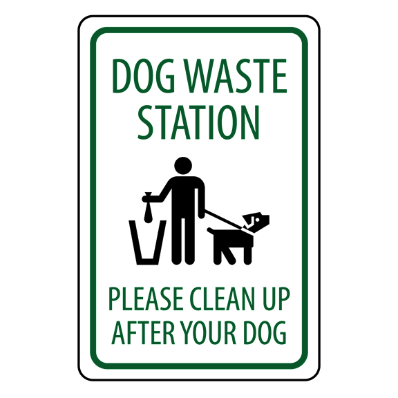 A sign instructs dog owners to clean up after their pets.