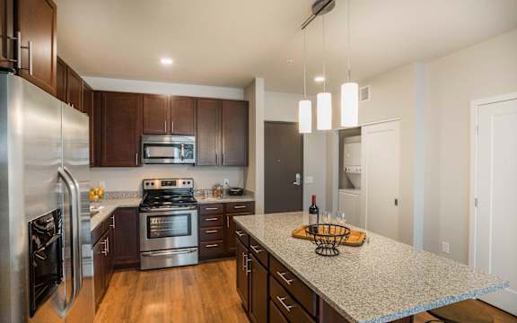 a kitchen with stainless steel appliances and granite counter tops