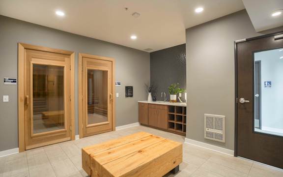 a large room with a wooden table in the center and two doors