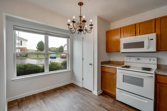 Kitchen With Wood-Style Flooring & Large Windows