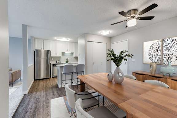 A modern kitchen with a dining table and chairs.