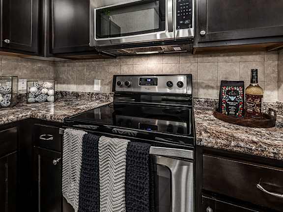 A black and white striped towel is draped over a stove.