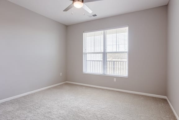 Bedroom with Large Window and Ceiling Fan