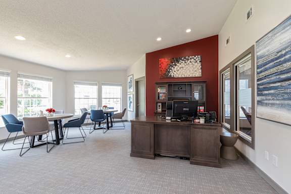 A reception area with a desk and chairs.