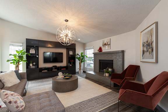 A living room with a fireplace and a television.