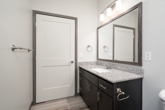 Large Granite Bathroom Vanity With Overhead Lighting In The Starling Floor Plan