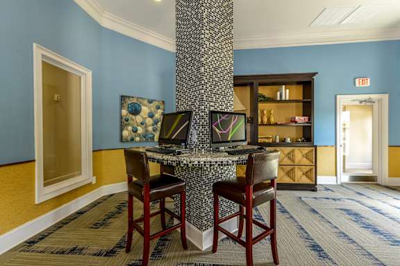 High-Top Tables With Computers At Clubhouse