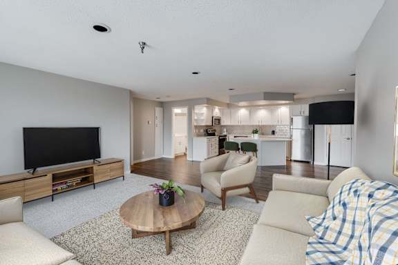 An open living room with a flat screen TV and a coffee table.